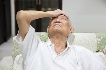 Obraz premium Asian Senior Man Grab His Forehead Suffer From Headache