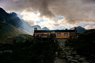Mountain chalet Zbojnicka chata in evening light on a cloudy day in the High Tatras mountains in Slovakia