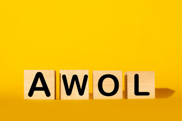 wooden cubes and AWOL on a yellow background.the concept of taxation, increase taxes