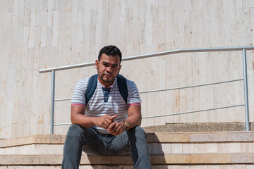 Student sitting on staircase in front of university building
