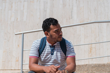 Student sitting on staircase in front of university building