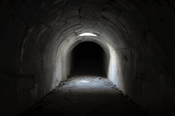 A sunlit exit from a dark dungeon. Light at the end of the tunnel, exit from the underground passage.