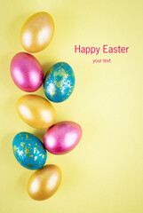 Fototapeta na wymiar Bright gold and multi-colored colored eggs on a yellow background. Easter theme, holiday. Happy easter card with copy space for text in minimalist easter style. Yellow, gold. Happy Easter