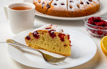 Close-up of sliced cherry pie, slice of pie on a plate and lemon tea. Selective focus, horizontal orientation.