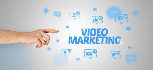 Close-Up of cropped hand pointing at VIDEO MARKETING inscription, social networking concept