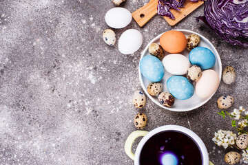 Process of painting Easter eggs in blue