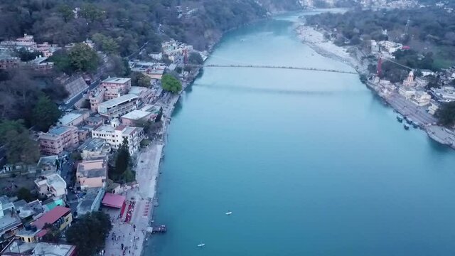 Aerial View Of Ram Jhula, A Suspension Bridge Across Ganges River In Rishikesh, India - drone shot