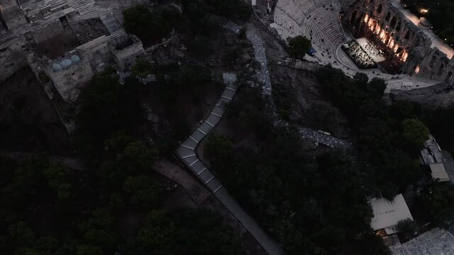 Ruins Of Ancient Theater Under Acropolis Of Athens, Greece - aerial drone shot