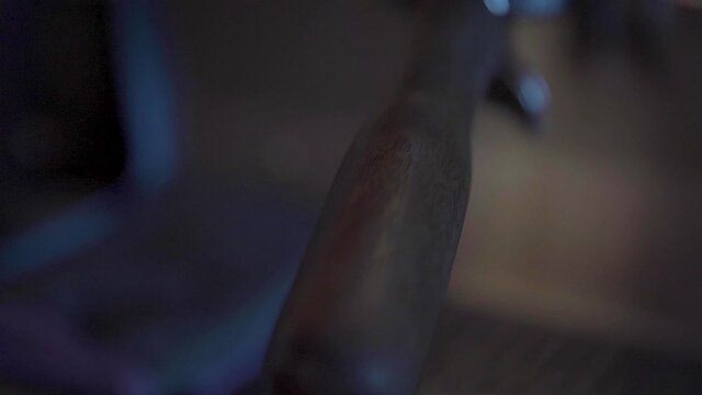 Slow-motion view of the handle of a coffeemaker with a blurry background.