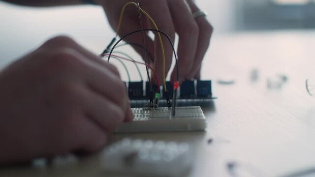 close up of a guy experimenting with a pcb board