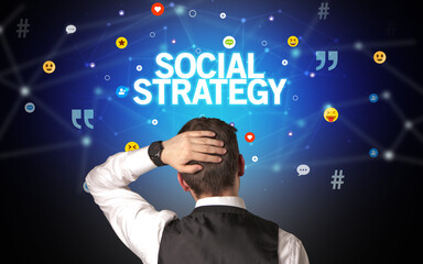 Rear view of a businessman with SOCIAL STRATEGY inscription, social networking concept