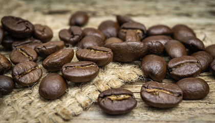 coffee beans on old natural wood background close up