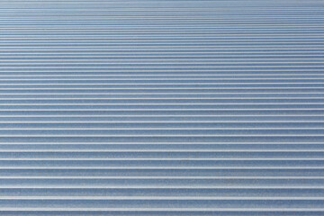 The background is formed by a corrugated galvanized sheet