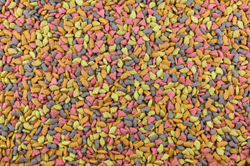 The background is made up by the colorful cat feed.