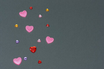Multicolored hearts on gray background with copy space