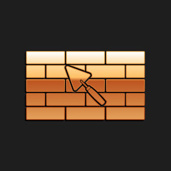 Gold Brick wall with trowel icon isolated on black background. Long shadow style. Vector.