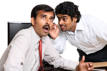 Indian young business people gossip in the office