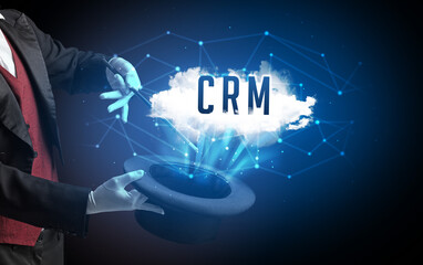 Magician is showing magic trick with CRM abbreviation, modern tech concept
