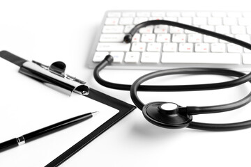 Fototapeta na wymiar Stethoscope, pen, clipboard and keyboard on white background. Medical concept. Closeup.