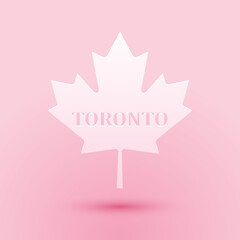 Obraz na płótnie Canvas Paper cut Canadian maple leaf with city name Toronto icon isolated on pink background. Paper art style. Vector.