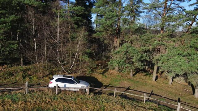 Lviv, Ukraine - December 28, 2020: BMW suv car at the trail road near farm field