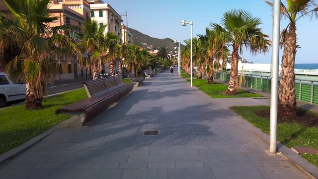 Varazze promenade at sunset with only one person walking alone
