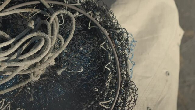 Close shot of fishing ropes and nets on the deck of a fishing boat.