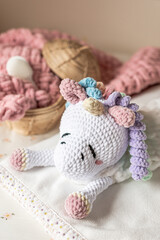 Fototapeta na wymiar Handmade pajama bag first baby toy unicorn, sleepwear organizer