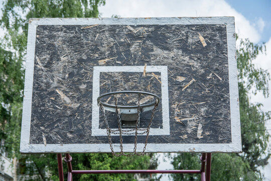 Black and white, wooden basketball board, with metallic chain hoop 