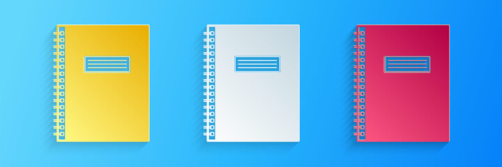 Paper cut Notebook icon isolated on blue background. Spiral notepad icon. School notebook. Writing pad. Diary for business. Office stationery items. Paper art style. Vector.