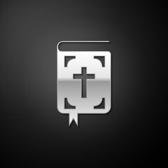 Silver Bible book icon isolated on black background. Holy Bible book sign. Long shadow style. Vector.