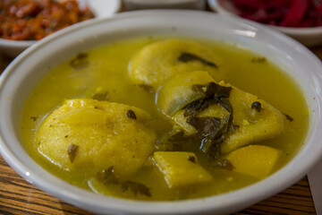 Traditional hot yellow Kubbe soup, a famous middle eastern dumplings soup dish, served in a bowl. Jerusalem, Israel. 