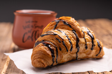 Delicious snack croissant on wood