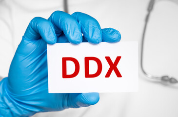 Doctor holding a card with text DDX Differential diagnosis, medical concept