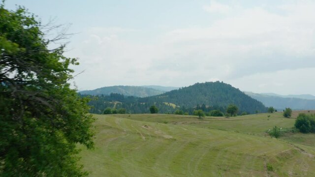 Green hills and Ticje polje village, Prijepolje serbia. Aerial landscape, establishing shot