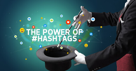 Magician is showing magic trick with THE POWER OF #HASHTAGS inscription, social media marketing concept