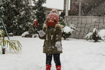 girl playing with snow