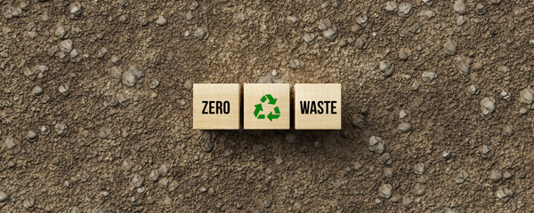 cubes with message ZERO WASTE on dirt gravel background