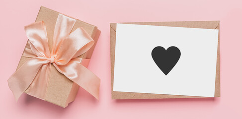 Gifts with note letter on isolated pink background, love and valentine concept with heart