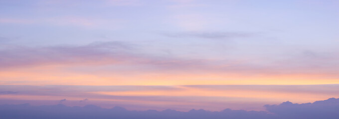 The morning sky looked like a bright golden sky. The sunrise is decorated with clouds in various shapes. Looks beautiful.