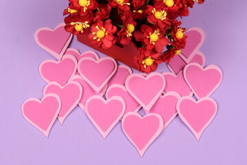 red box with flowers next to a heart and lilas background