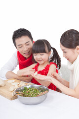 Portrait of daughter with parents making dumplings 