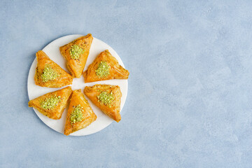 Sweets arabic dessert baklava, warbat, kunafa, kadayif with pistachio and cheese . Top view, copy...