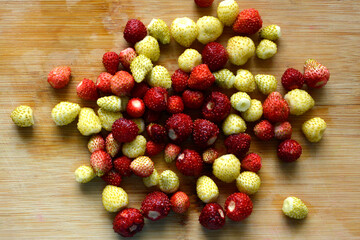 Fresh strawberries on the table. Red and white strawberries. Background with fruits.