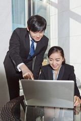 Fototapeta premium Business man and business woman using laptop