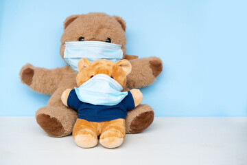 stuffed toy bear wearing protective medical face mask