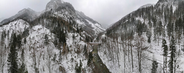 Snowy Winter Alps Panorama with river, bridge and street