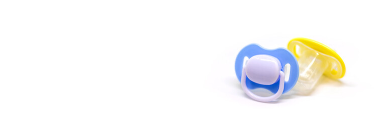 Dummy pacifiers for newborns in different colors. Selective focus.
