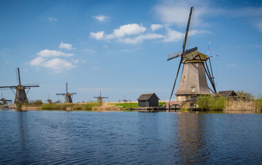 Fototapeta na wymiar Nine windmills in Holland Holland field by water