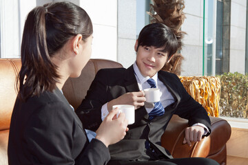 Business man and business woman drinking coffee